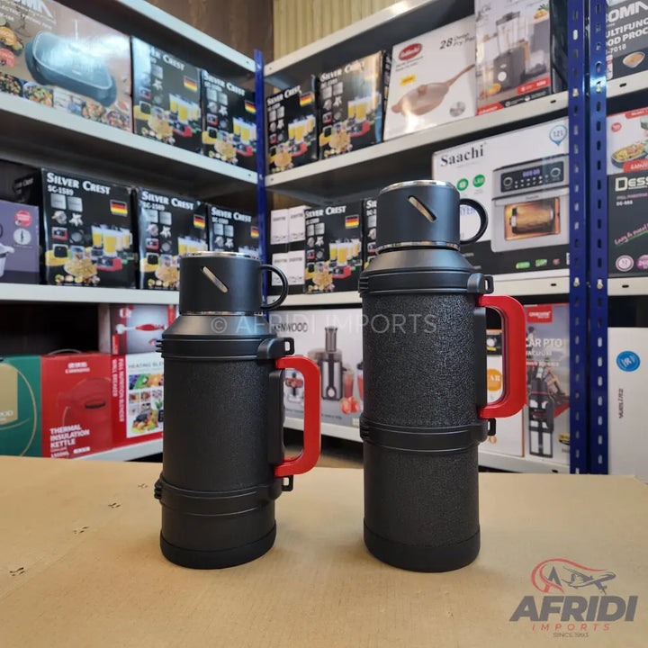 Two black thermal flasks with red handles.