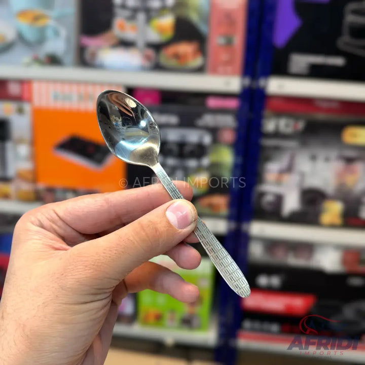 A shiny metal spoon with a textured handle.