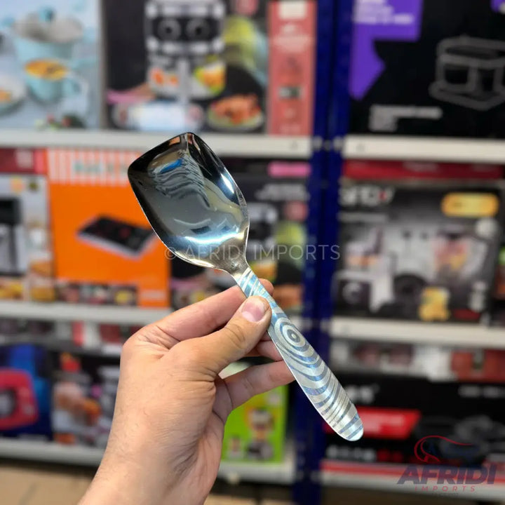 A stainless steel serving spoon with a patterned handle.