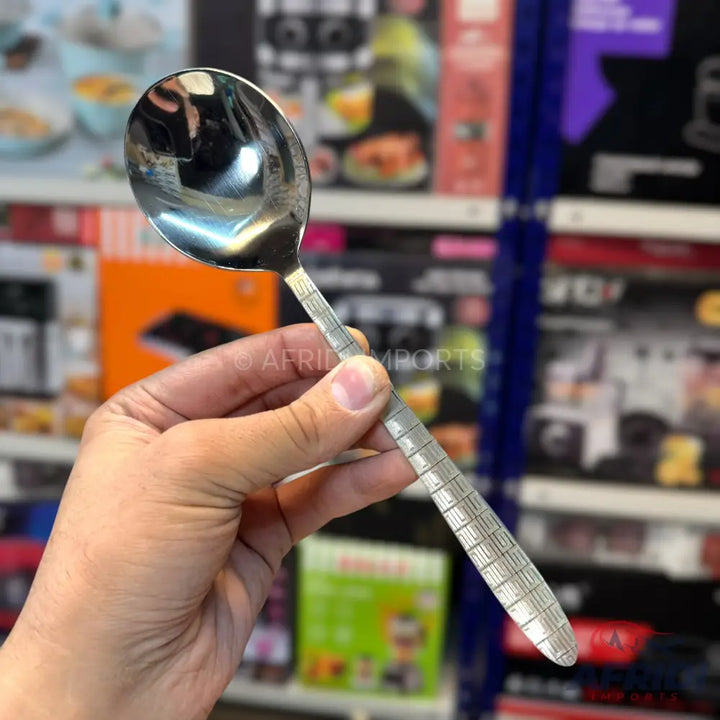 A shiny silver metal spoon with a textured handle.
