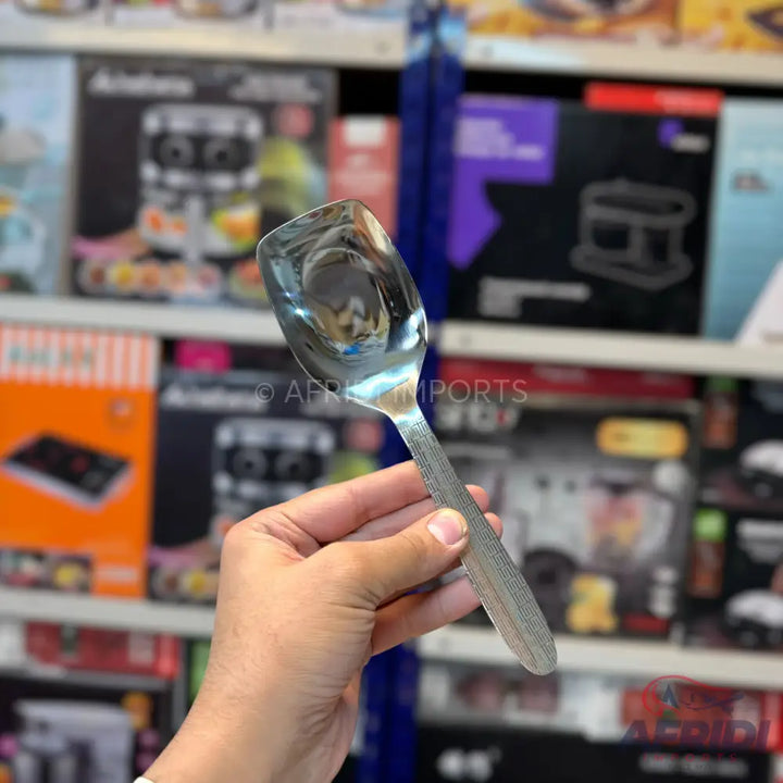 Shiny stainless steel serving spoon with a textured handle.