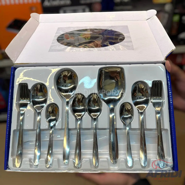 A boxed set of stainless steel cutlery, including various sizes of spoons and forks.