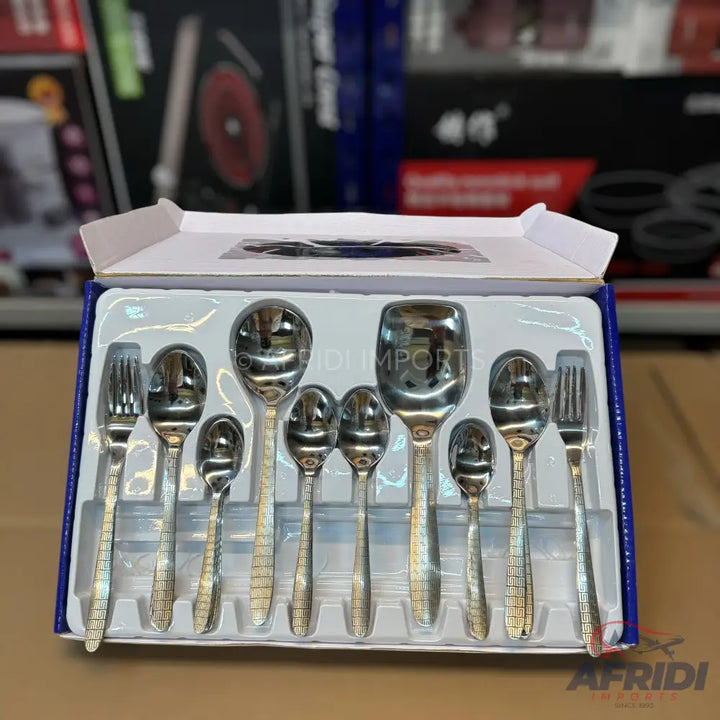 A boxed set of stainless steel cutlery, including various sizes of spoons and forks.