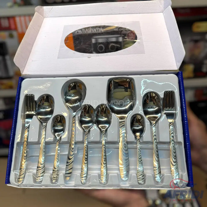 A boxed set of stainless steel cutlery with patterned handles.