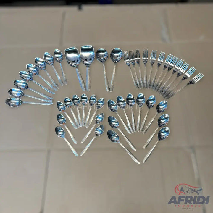 A collection of shiny silver-colored spoons and forks with textured handles.