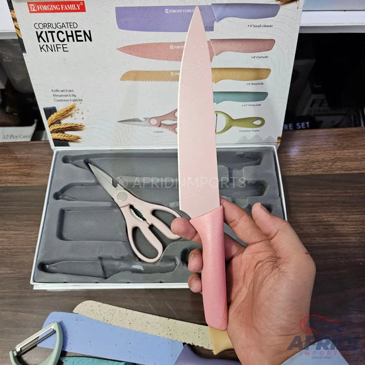 A pink chef’s knife from a colorful kitchen knife set.