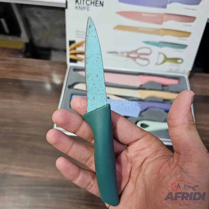 A teal-bladed kitchen knife with a dark green handle.