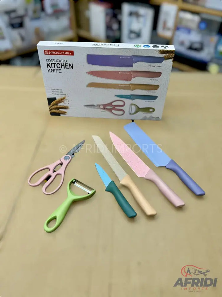 A colorful set of kitchen knives, scissors, and a peeler.