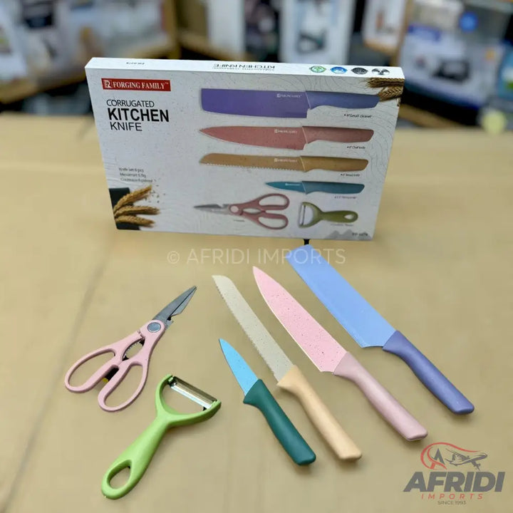 A colorful set of corrugated kitchen knives, a peeler, and scissors.