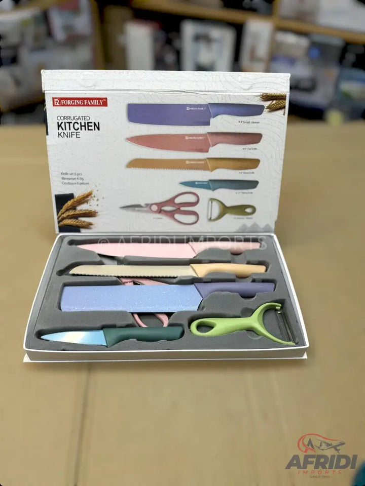 A colorful set of corrugated kitchen knives with a peeler and scissors.