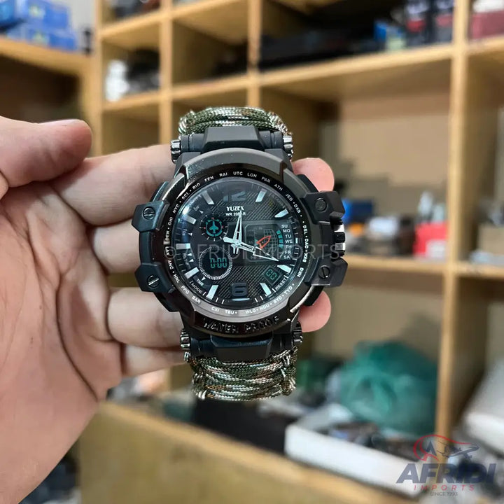 A black tactical wristwatch with a camouflage paracord strap.