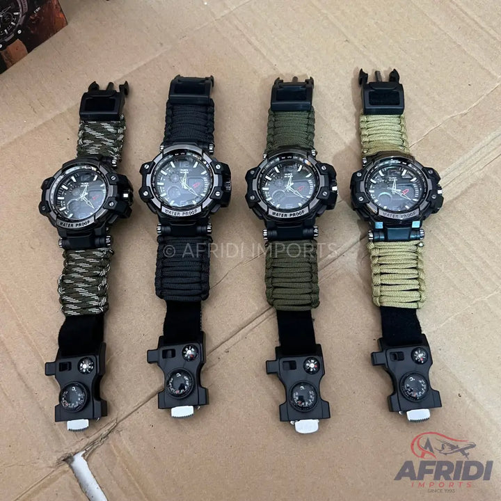 Four tactical survival watches with paracord straps and compass buckles.