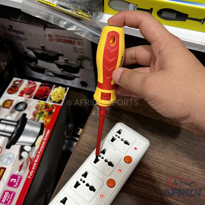 A yellow and red insulated screwdriver with a flat head, designed for electrical work.