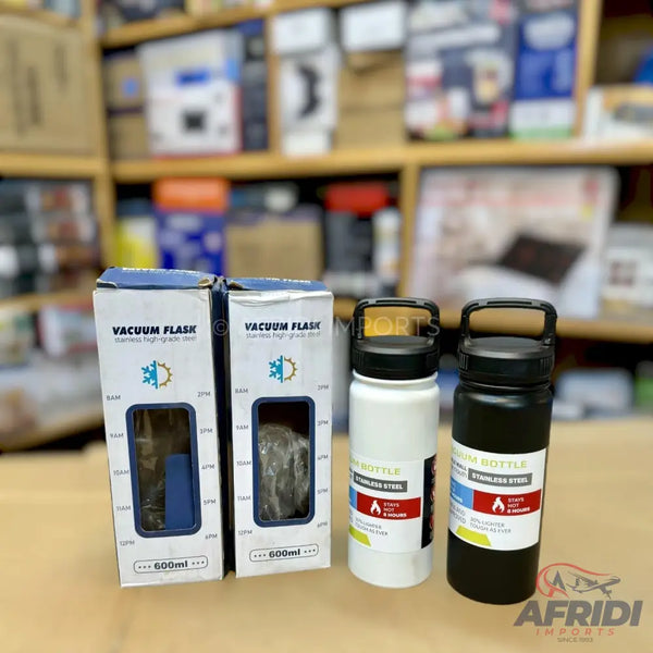 Two boxed and two unboxed stainless steel vacuum insulated water bottles with carrying handles.