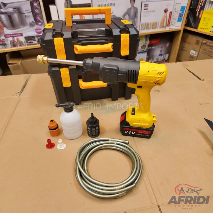 A cordless portable pressure washer with accessories and a carrying case.