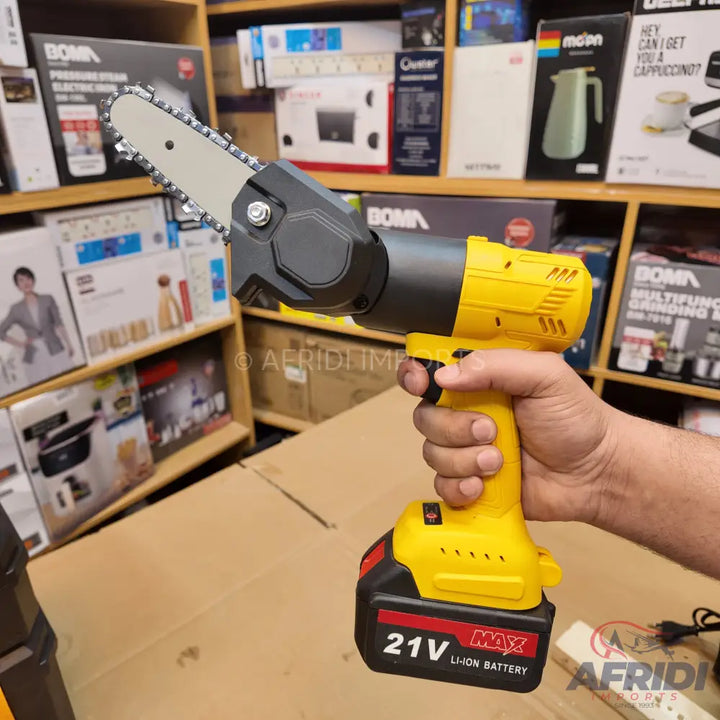 Yellow and black cordless handheld mini chainsaw with a lithium-ion battery.