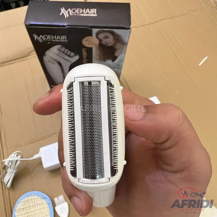 A handheld white electric shaver with a foil head and trimmers.