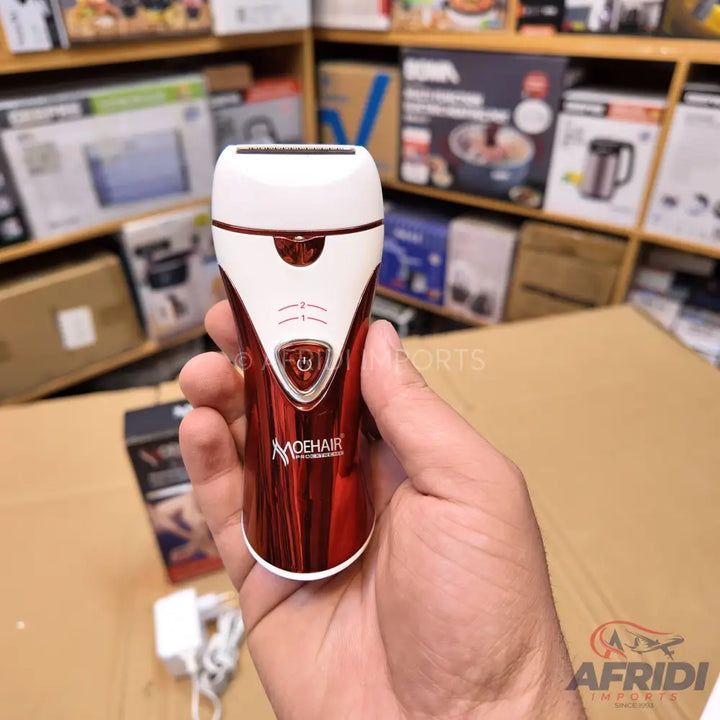 Red and white electric shaver with a power button and speed indicators.