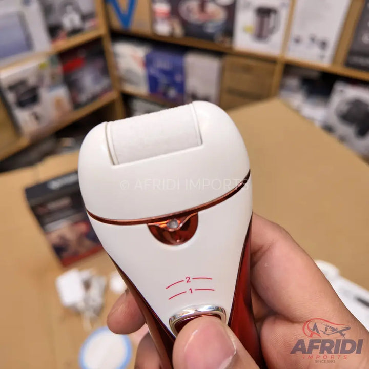 A white and rose gold electric foot file with two speed settings.