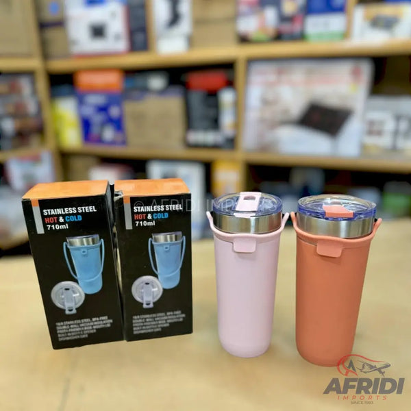 Two stainless steel hot and cold travel mugs with handles, one pink and one peach, with their respective packaging boxes.