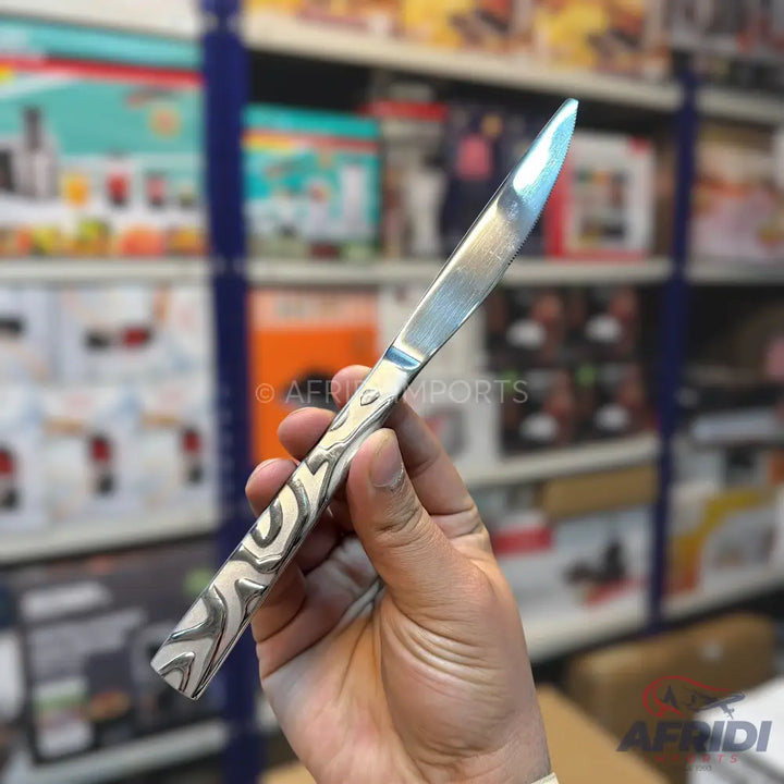 A silver-colored knife with a patterned handle.