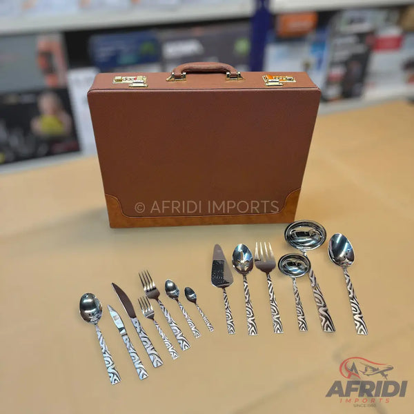 A brown leather-bound briefcase containing a set of silver-colored, patterned cutlery.