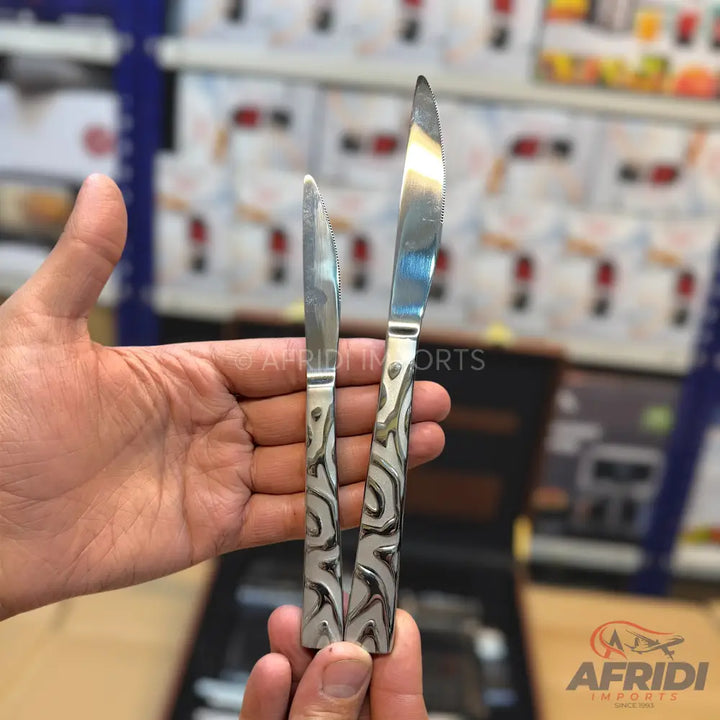 Two stainless steel knives with decorative, patterned handles.