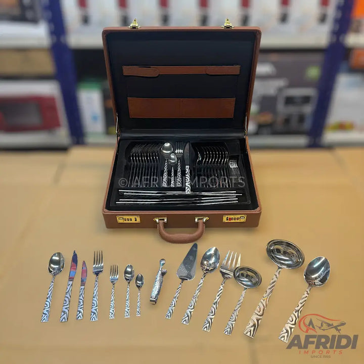 A comprehensive set of silverware in a brown carrying case, featuring various utensils with decorative handles.
