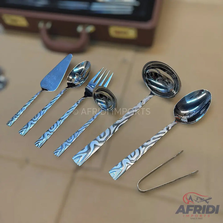 A set of stainless steel serving utensils with textured, wavy handles.