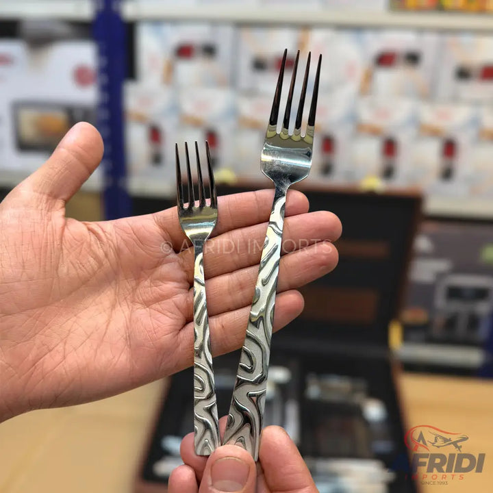 Two stainless steel forks with decorative, wavy handles.