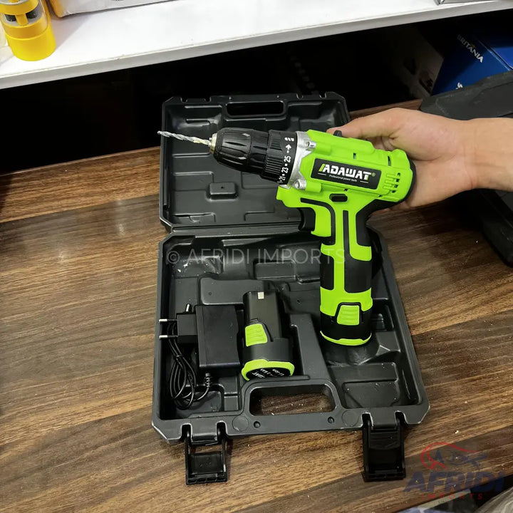 A green and black cordless drill kit with two batteries and a charger, neatly organized in a black carrying case.