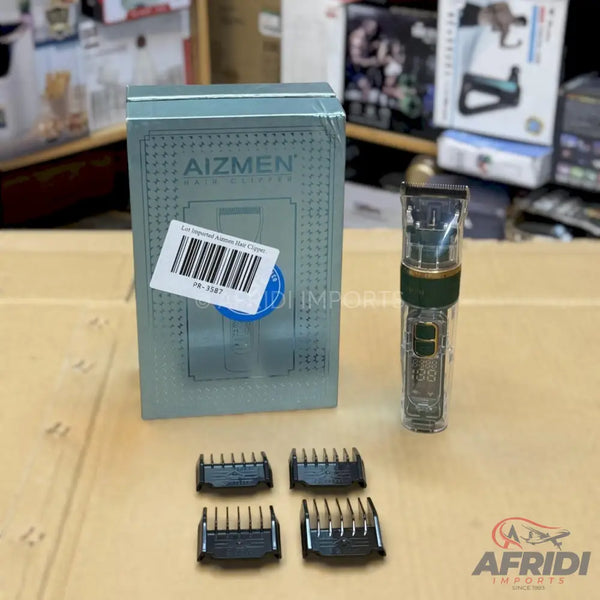 A transparent hair clipper with a green band, digital display, four attachment combs, and its product box.