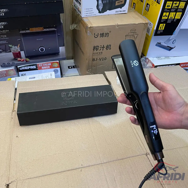 A black hair straightener with a digital temperature display.