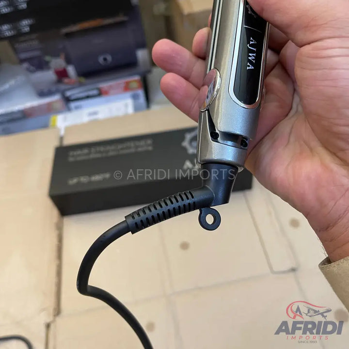 A silver and black hair straightener with a swivel cord.