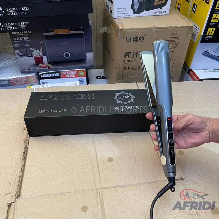 A grey and black hair straightener with digital temperature display.