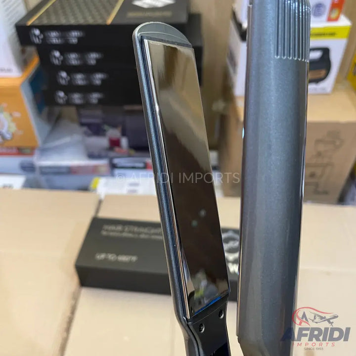Sleek black and gray hair straightener with a reflective heating plate.