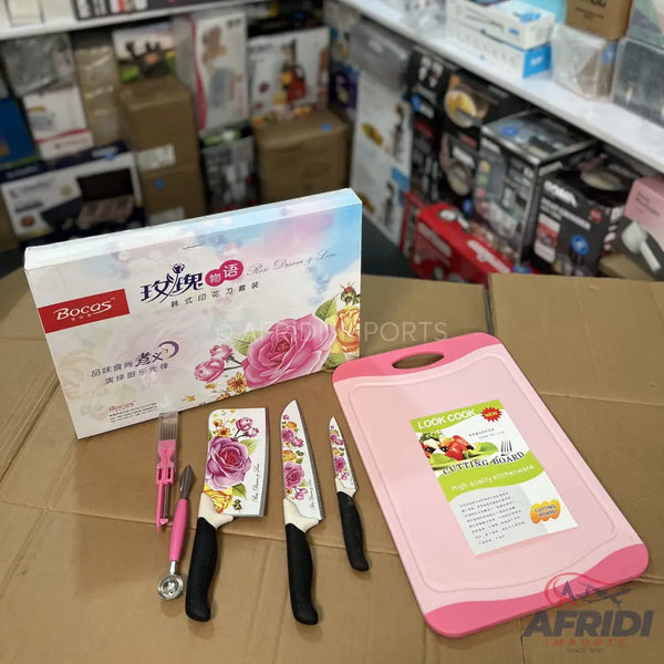 A set of kitchen knives with floral-patterned blades and a matching pink cutting board.