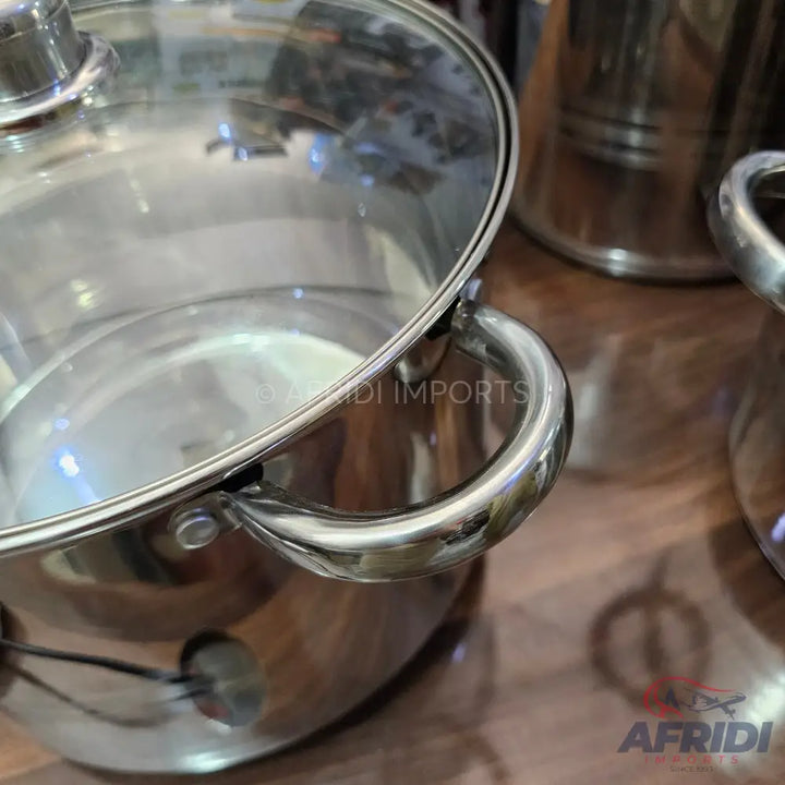 Stainless steel cooking pot with a glass lid and side handles.