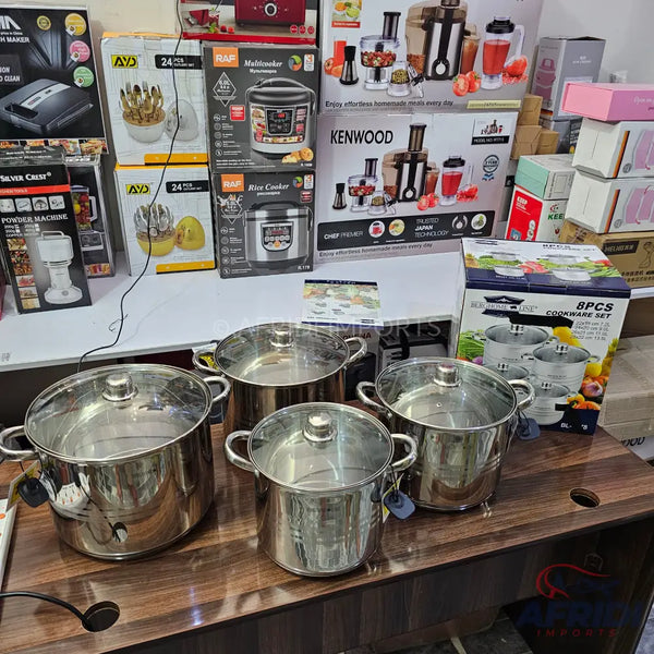 A collection of stainless steel pots with glass lids.