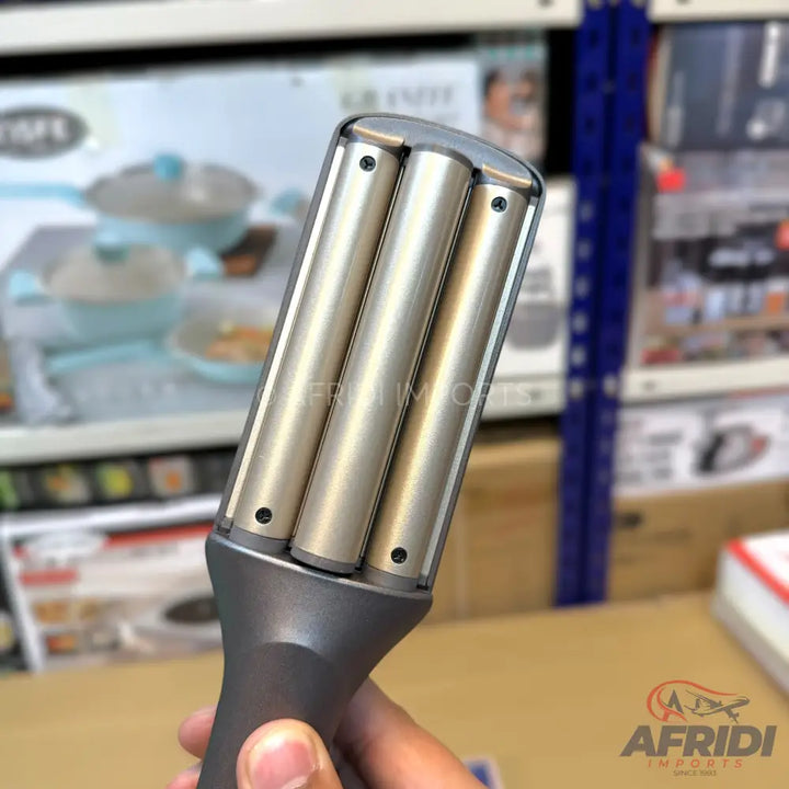 A three-barrel hair waver with a grey handle.