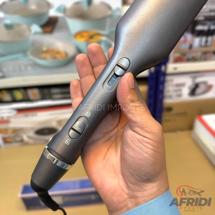 Dark gray hair straightener with two sliding lock/unlock buttons.