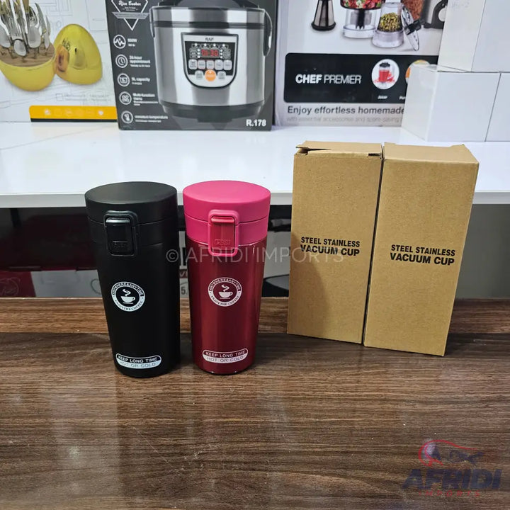 Two insulated stainless steel vacuum cups, one black and one red, with flip-top lids.