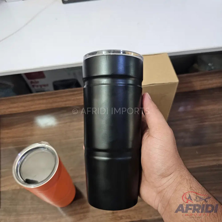A black insulated tumbler with a clear lid.