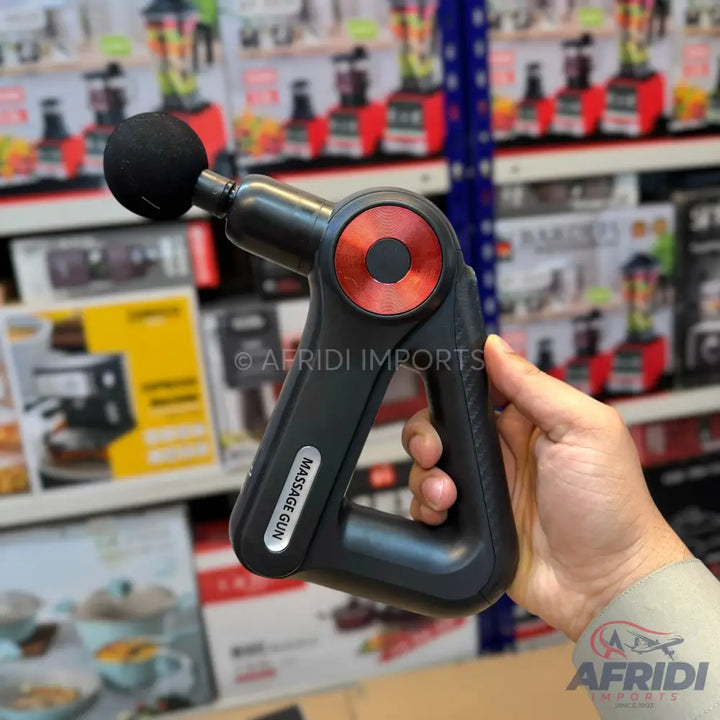 Black massage gun with a red circular accent and a ball-shaped attachment.