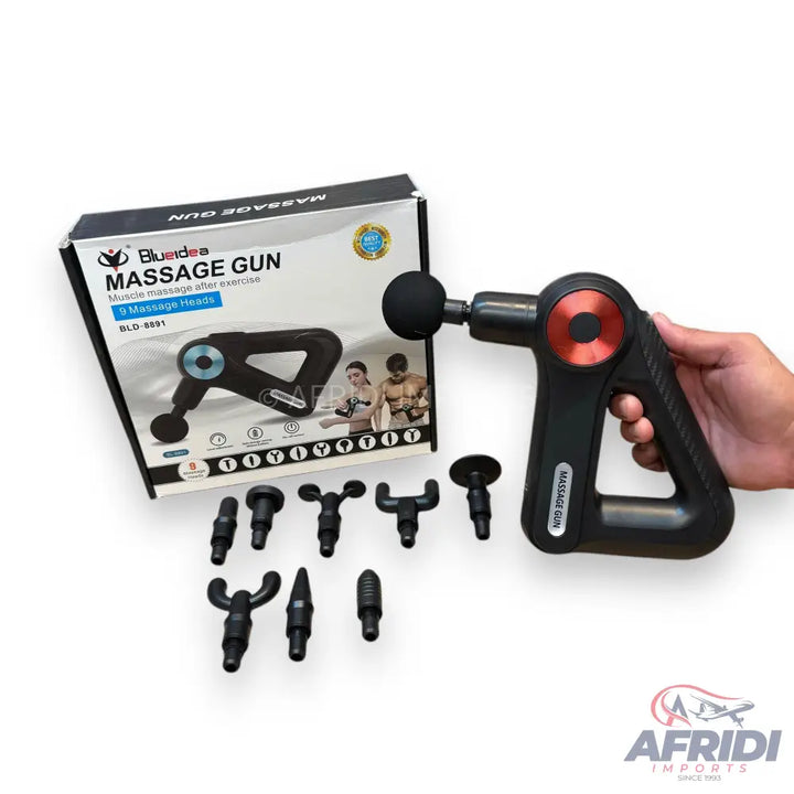 A black massage gun with multiple interchangeable heads and its retail packaging.