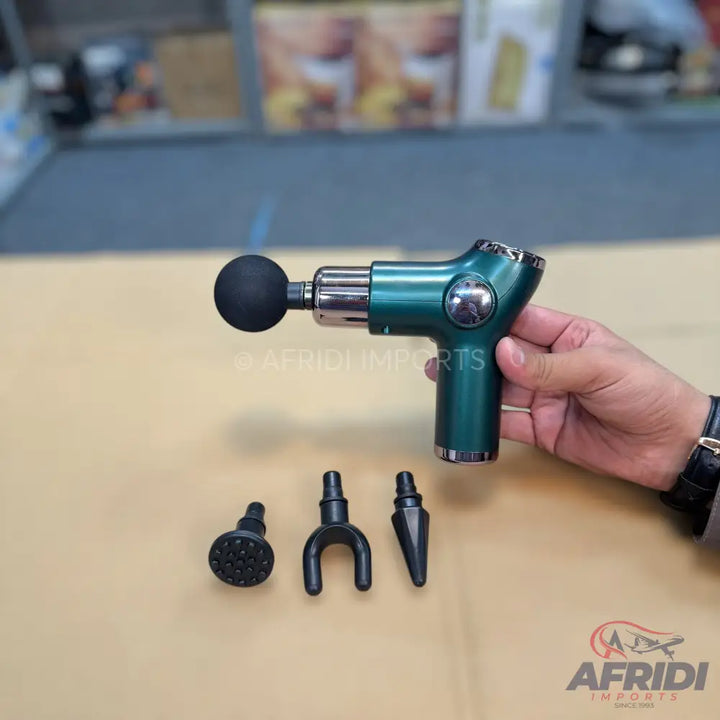 A teal handheld massage gun with four interchangeable head attachments.