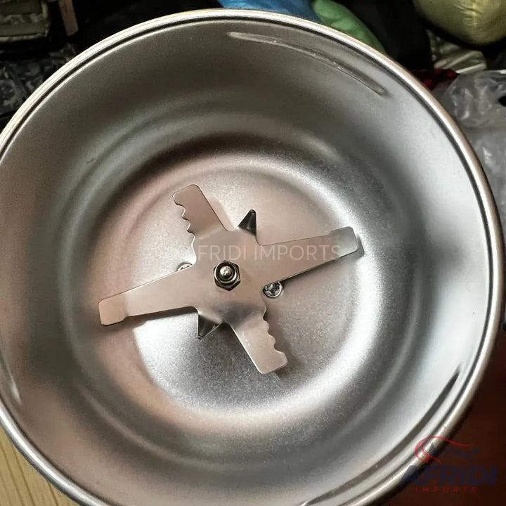 Stainless steel grinding bowl with a four-pronged blade.
