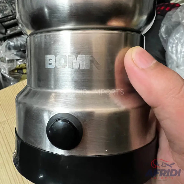 A brushed stainless steel electric coffee grinder with a black base and push-button control.