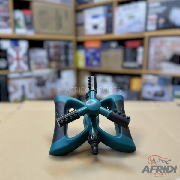 Teal and black rotating garden sprinkler.