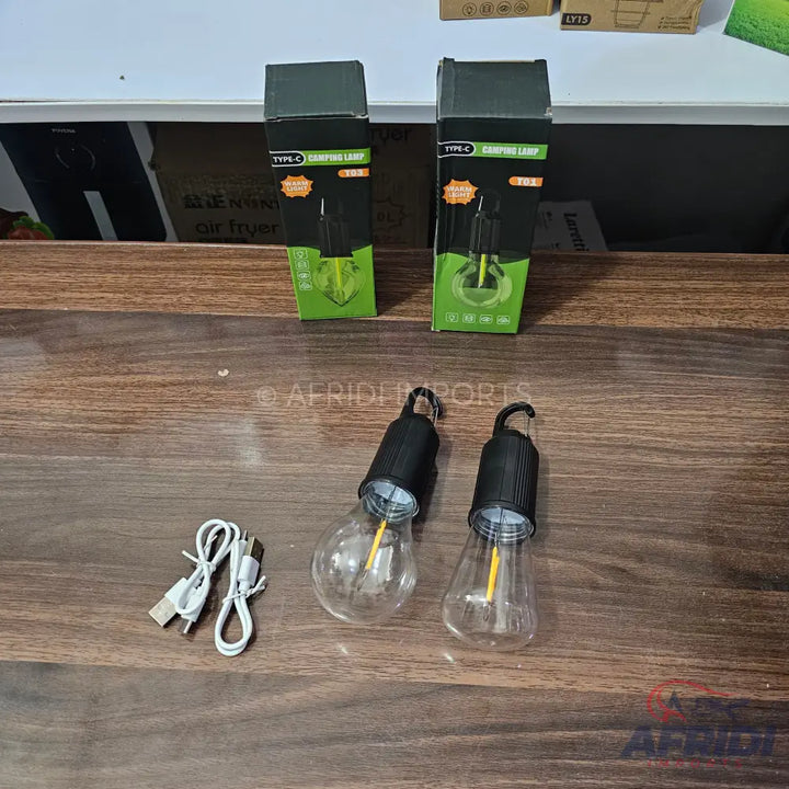 Two camping lightbulbs with USB-C charging cables.